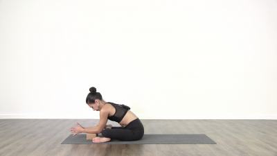 Yogi is practising yoga on a blue yoga mat on white background