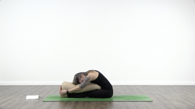 Lauren matters is practising yoga on a green yoga mat
